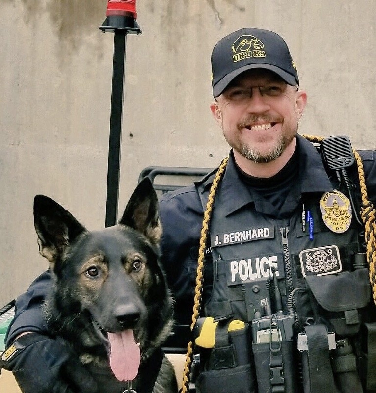 K9 Jago and Officer Bernhard pose for a photo on game day.